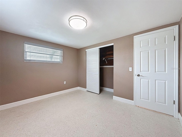 unfurnished bedroom featuring a closet and baseboards