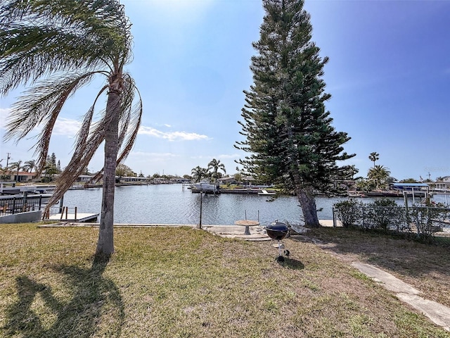 dock area featuring a yard and a water view