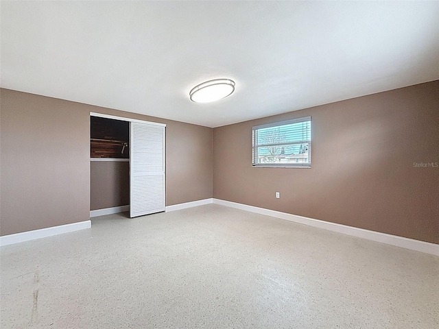 unfurnished bedroom with a closet and baseboards