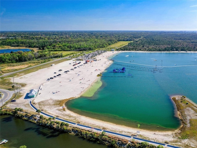 birds eye view of property featuring a forest view and a water view