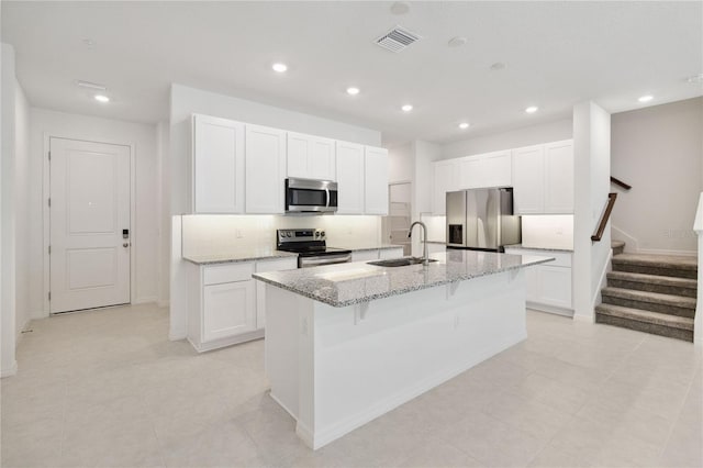 kitchen with a kitchen island with sink, visible vents, a sink, stainless steel appliances, and recessed lighting