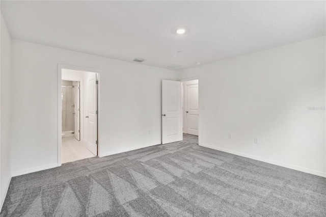 unfurnished bedroom with visible vents, carpet flooring, and baseboards