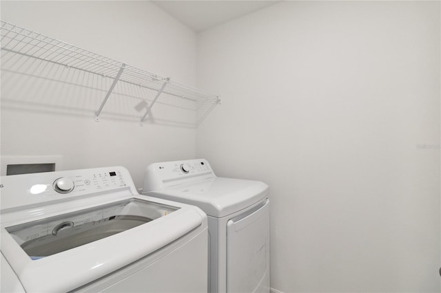 clothes washing area featuring laundry area and washing machine and dryer