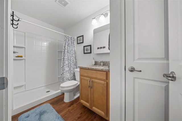 16386 Heron Hills Dr, Spring Hill, FL 34610 - bathroom with vanity, wood finished floors, visible vents, and a stall shower
