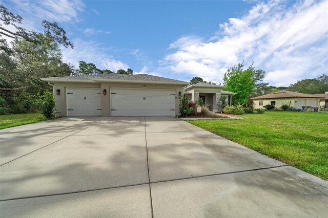16386 Heron Hills Dr, Spring Hill, FL 34610 - ranch-style home with an attached garage, concrete driveway, a front lawn, and stucco siding