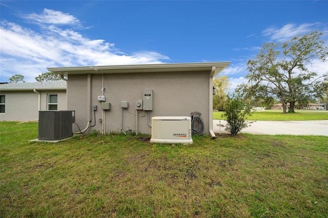 16386 Heron Hills Dr, Spring Hill, FL 34610 - back of house featuring a yard, central AC unit, and stucco siding