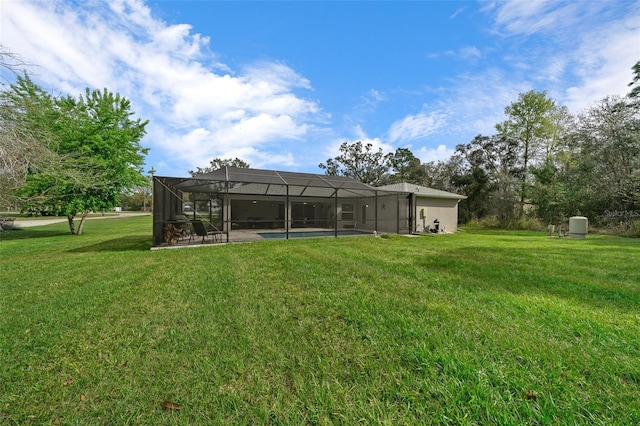 16386 Heron Hills Dr, Spring Hill, FL 34610 - back of house featuring glass enclosure, a yard, and a patio area