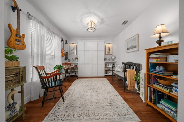 16386 Heron Hills Dr, Spring Hill, FL 34610 - living area featuring baseboards, dark wood-style flooring, and visible vents