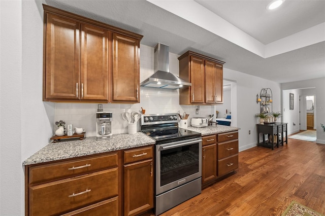 16386 Heron Hills Dr, Spring Hill, FL 34610 - kitchen featuring dark wood-style flooring, tasteful backsplash, stainless steel range with electric stovetop, and wall chimney range hood