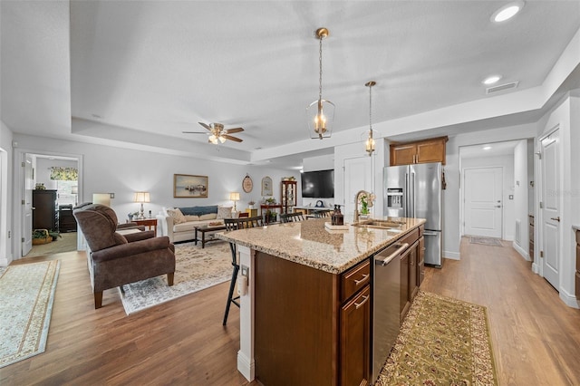 16386 Heron Hills Dr, Spring Hill, FL 34610 - kitchen with wood finished floors, a sink, a raised ceiling, appliances with stainless steel finishes, and visible vents