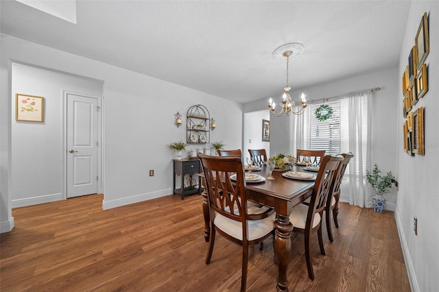 16386 Heron Hills Dr, Spring Hill, FL 34610 - dining room with wood finished floors, baseboards, and a chandelier