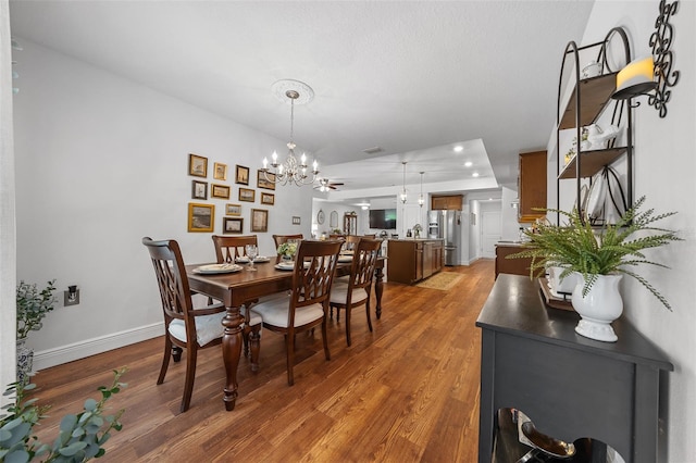 16386 Heron Hills Dr, Spring Hill, FL 34610 - dining area with wood finished floors, an inviting chandelier, baseboards, visible vents, and recessed lighting