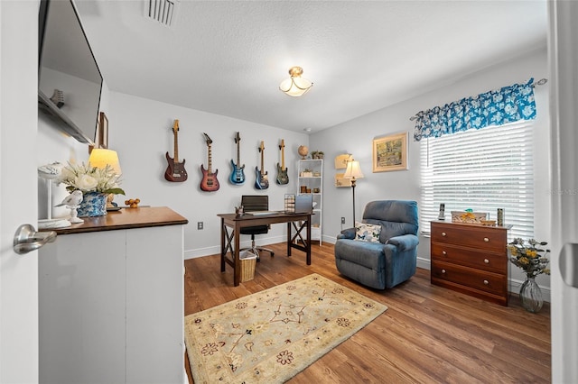 16386 Heron Hills Dr, Spring Hill, FL 34610 - living area with baseboards, wood finished floors, and visible vents
