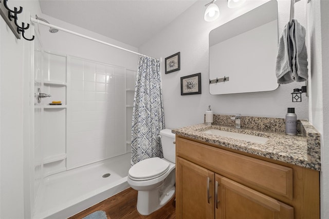 16386 Heron Hills Dr, Spring Hill, FL 34610 - full bathroom with toilet, vanity, wood finished floors, and a stall shower