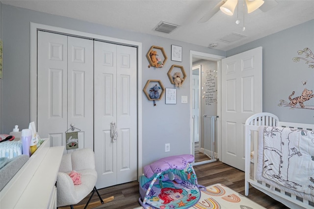 bedroom featuring a closet, visible vents, a ceiling fan, and wood finished floors