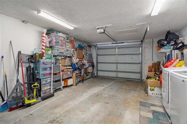 garage with independent washer and dryer and a garage door opener