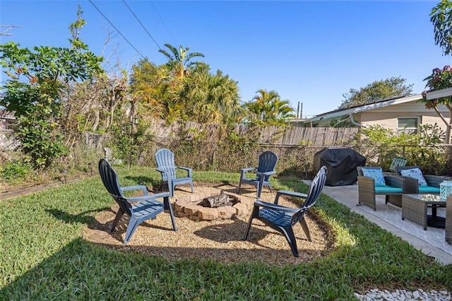 view of yard featuring a patio area, fence, and an outdoor fire pit