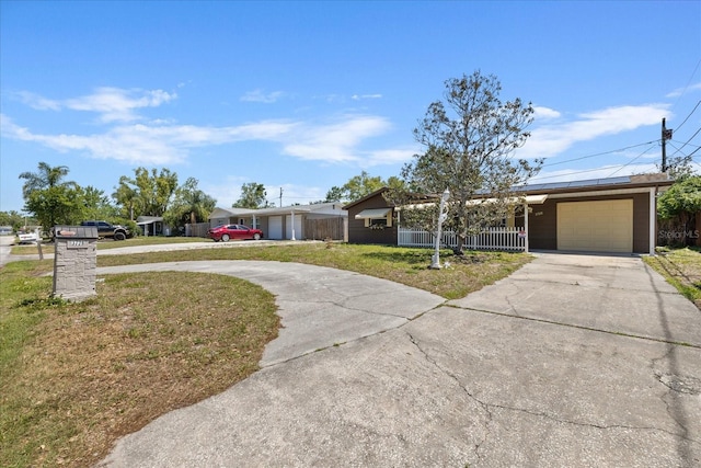 3728 Linkwood St, New Port Richey, FL 34652 - single story home with concrete driveway, fence, a garage, roof mounted solar panels, and a front yard