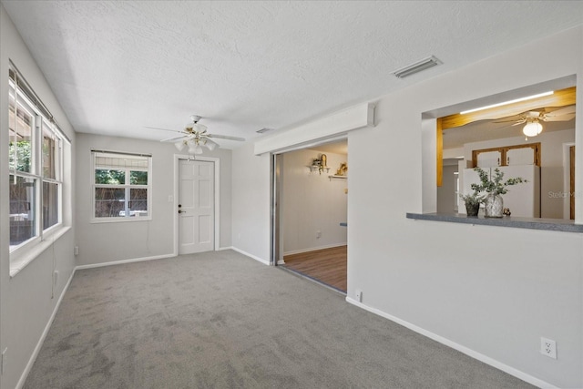 3728 Linkwood St, New Port Richey, FL 34652 - carpeted empty room featuring baseboards, visible vents, a textured ceiling, and ceiling fan