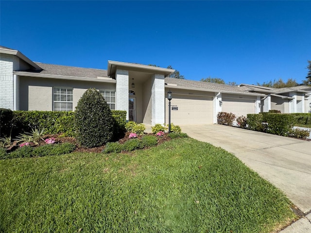 view of front of home with brick siding, driveway, a front lawn, and a garage