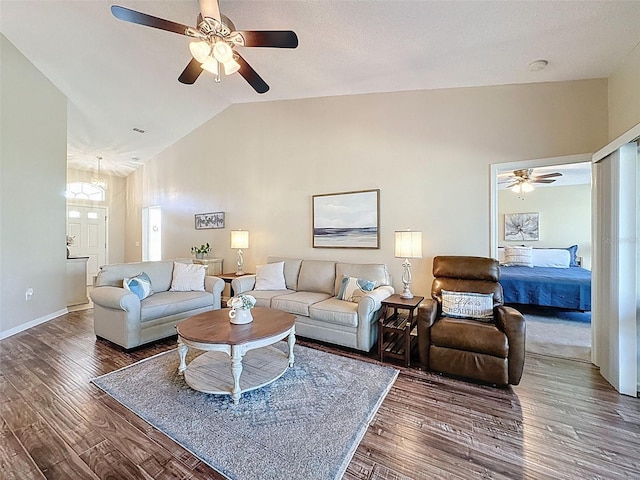 living area with ceiling fan, baseboards, lofted ceiling, and wood finished floors