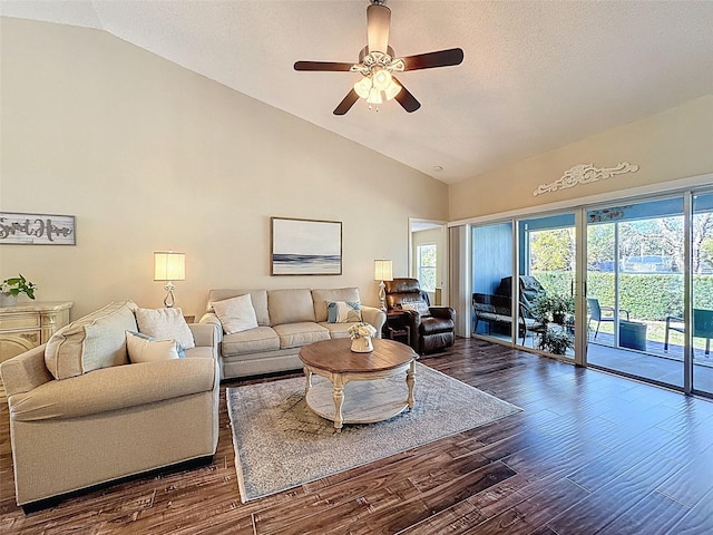 living room with dark wood finished floors, a textured ceiling, high vaulted ceiling, and a ceiling fan