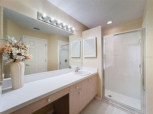 full bath with vanity, visible vents, a stall shower, a textured ceiling, and marble finish floor