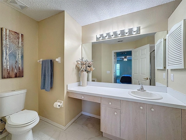 ensuite bathroom featuring visible vents, toilet, marble finish floor, a textured ceiling, and baseboards