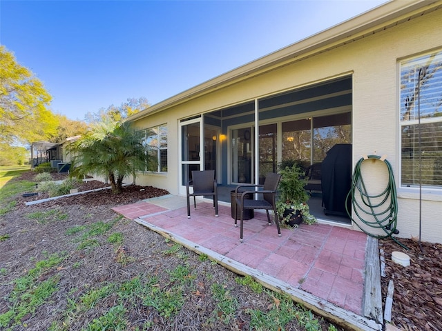 view of patio featuring a sunroom