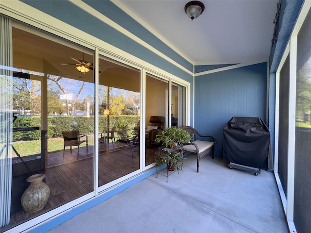 sunroom featuring ceiling fan