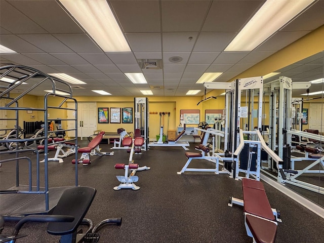 exercise room featuring a paneled ceiling and visible vents