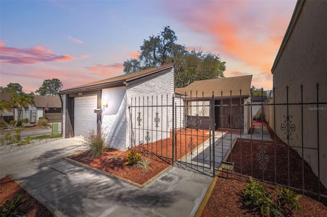 exterior space with concrete driveway and fence