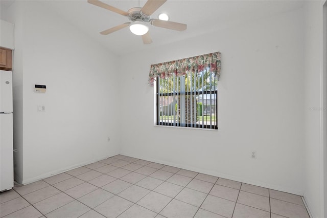 empty room with light tile patterned floors, baseboards, and ceiling fan