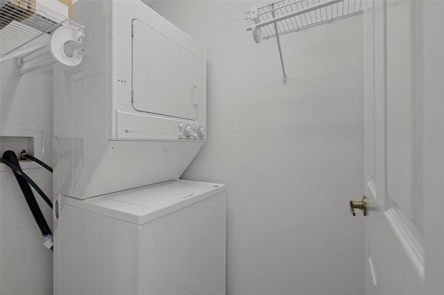 washroom featuring laundry area and stacked washer and clothes dryer