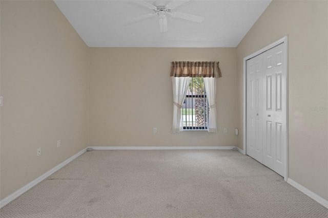 spare room with a ceiling fan, carpet, and baseboards