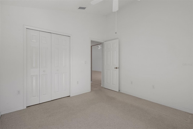 unfurnished bedroom with light colored carpet, visible vents, a closet, and baseboards