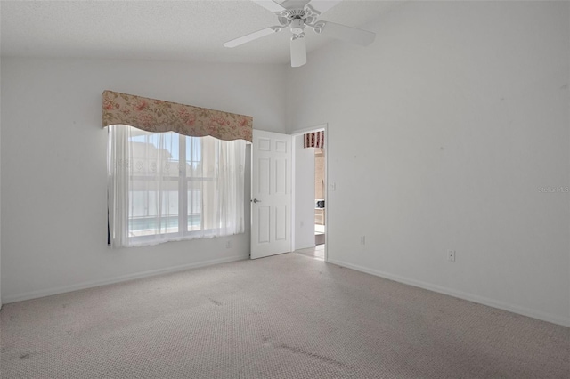 unfurnished room with high vaulted ceiling, carpet, baseboards, and ceiling fan