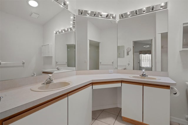 bathroom featuring double vanity, tile patterned floors, and a sink