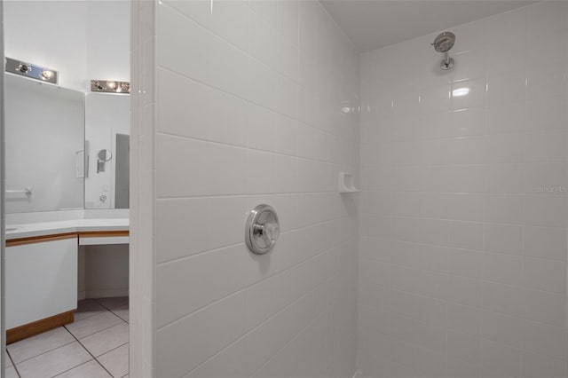 bathroom with vanity, tile patterned floors, and a tile shower