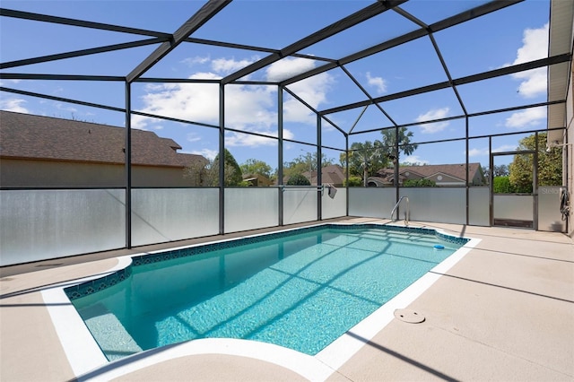 view of swimming pool with glass enclosure, a patio area, and a fenced in pool