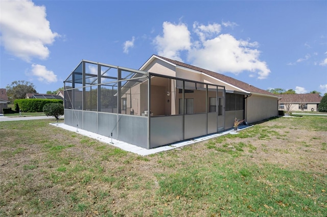 view of property exterior with a yard, a lanai, and stucco siding