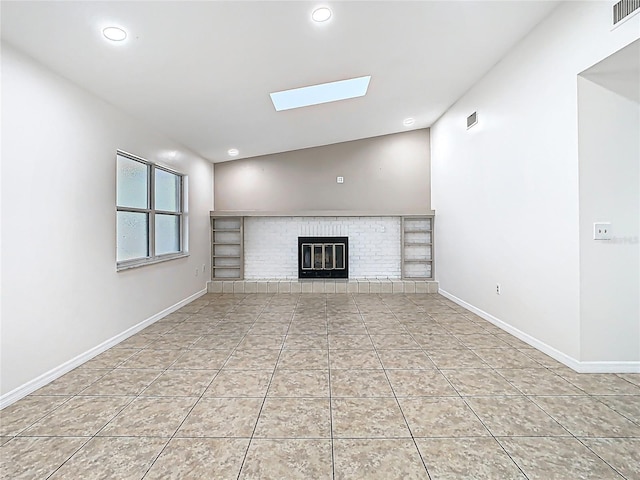 unfurnished living room with visible vents, recessed lighting, a fireplace, tile patterned flooring, and baseboards