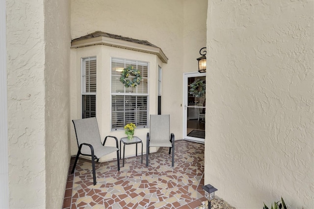 doorway to property with stucco siding and a patio