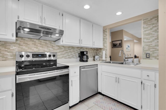 kitchen with light tile patterned flooring, a sink, light countertops, under cabinet range hood, and appliances with stainless steel finishes