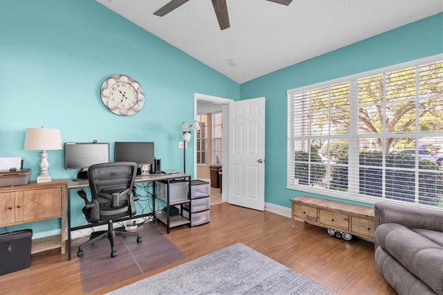 home office featuring baseboards, wood finished floors, lofted ceiling, and ceiling fan