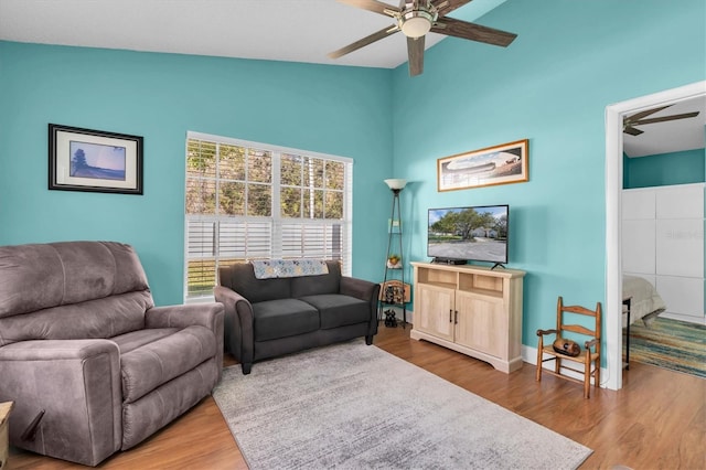 living room featuring ceiling fan and wood finished floors