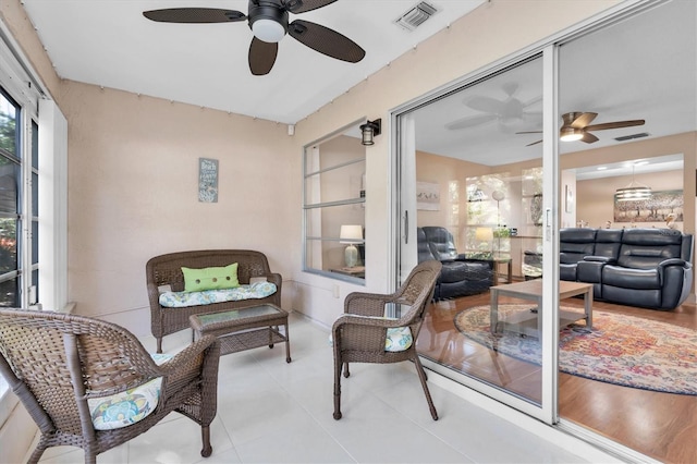 sunroom with visible vents and a ceiling fan