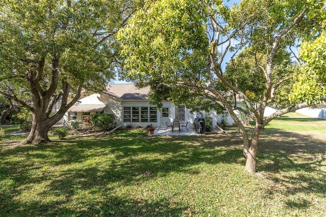 exterior space featuring a front yard and a patio area