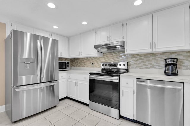 kitchen featuring under cabinet range hood, stainless steel appliances, light countertops, light tile patterned floors, and decorative backsplash