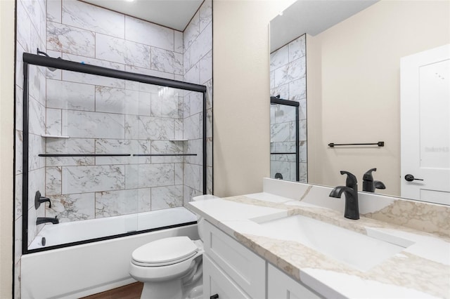 full bath with combined bath / shower with glass door, toilet, and vanity